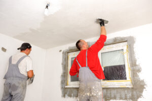 Construction workers painting walls